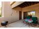 Outdoor patio with table and colorful tablecloth, two chairs, and barbecue grill on the concrete at 16626 E Westby Dr # 108, Fountain Hills, AZ 85268