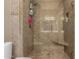 Tiled shower with glass door and a built-in seat and shelf for added convenience at 16626 E Westby Dr # 108, Fountain Hills, AZ 85268