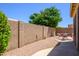 Charming backyard featuring a gravel area, block wall, and outdoor seating area with a table and chairs at 17640 W Babbitt Dr, Surprise, AZ 85374