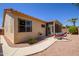 Nice backyard view with a walkway, patio area, seating, and low-maintenance desert landscaping with lots of sun at 17640 W Babbitt Dr, Surprise, AZ 85374