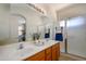 Bathroom featuring a double-sink vanity with tile flooring and a glass-enclosed shower at 17640 W Babbitt Dr, Surprise, AZ 85374