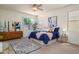 Serene bedroom featuring a large bed, dresser, and lots of natural light at 17640 W Babbitt Dr, Surprise, AZ 85374