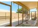 Enclosed patio with screened windows providing views to the exterior backyard at 17640 W Babbitt Dr, Surprise, AZ 85374
