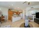 Open concept kitchen with an island, wooden cabinetry, and view into the living area at 17640 W Babbitt Dr, Surprise, AZ 85374