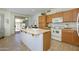 Bright kitchen with a center island, ample counter space, and access to the outdoor patio at 17640 W Babbitt Dr, Surprise, AZ 85374