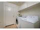 Functional laundry room with appliances and storage cabinets above the machines at 17640 W Babbitt Dr, Surprise, AZ 85374