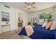 Cozy main bedroom with a king bed, dresser, and arched entryway to the bathroom at 17640 W Babbitt Dr, Surprise, AZ 85374