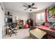 Cozy bedroom featuring a ceiling fan, a study desk, and a window with natural light at 17652 W Straight Arrow Ln, Surprise, AZ 85387