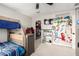 Bedroom featuring a bunk bed, ceiling fan, carpet, and a walk-in closet at 17652 W Straight Arrow Ln, Surprise, AZ 85387