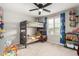 bedroom with a bunk bed, large window with blind, and bright blue patterned curtains at 17652 W Straight Arrow Ln, Surprise, AZ 85387