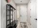 Modern entryway with a bench, storage rack, and neutral decor at 17652 W Straight Arrow Ln, Surprise, AZ 85387