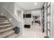 Inviting entryway with tiled floors and staircase with white railing to the upper level at 17652 W Straight Arrow Ln, Surprise, AZ 85387