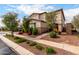 Charming two-story home with manicured landscaping and colorful desert flowers at 17652 W Straight Arrow Ln, Surprise, AZ 85387
