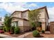 Charming two-story home with desert landscaping and colorful desert flowers at 17652 W Straight Arrow Ln, Surprise, AZ 85387