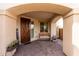 Inviting front porch featuring a wooden bench, welcome sign, and desert plants at 17652 W Straight Arrow Ln, Surprise, AZ 85387
