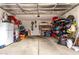 A spacious three car garage that provides storage solutions, and ample room for vehicles and equipment at 17652 W Straight Arrow Ln, Surprise, AZ 85387