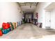 Spacious garage equipped with a car lift and organized storage solutions, providing ample space for vehicles and equipment at 17652 W Straight Arrow Ln, Surprise, AZ 85387