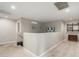 An open hallway with carpet flooring, neutral walls, and wall decor that adds character to the space at 17652 W Straight Arrow Ln, Surprise, AZ 85387
