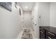 Bright hallway featuring neutral walls, decorative paintings and contrasting dark cabinets with metallic hardware at 17652 W Straight Arrow Ln, Surprise, AZ 85387