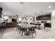 Open concept living room featuring a dining area, a large sofa, and a kitchen with granite countertops at 17652 W Straight Arrow Ln, Surprise, AZ 85387