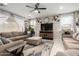 Cozy living room with ample seating, a ceiling fan, and bright natural light at 17652 W Straight Arrow Ln, Surprise, AZ 85387