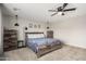 Nicely staged primary bedroom showcasing neutral walls and carpet, plus modern rustic furniture at 17652 W Straight Arrow Ln, Surprise, AZ 85387