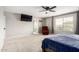 Bright primary bedroom featuring an en suite bathroom and plush red reading chair at 17652 W Straight Arrow Ln, Surprise, AZ 85387