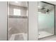 Modern bathroom shower featuring dual shower heads, light gray tiles, and a window at 17652 W Straight Arrow Ln, Surprise, AZ 85387