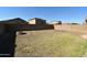 Large backyard featuring a brick wall surround and grass at 17829 W Sherman St, Goodyear, AZ 85338