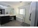 Bright bathroom featuring a soaking tub, glass enclosed shower, and double sink vanity at 17829 W Sherman St, Goodyear, AZ 85338