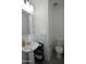 A half bathroom featuring a sink, toilet, mirror and towel ring in neutral tones at 17829 W Sherman St, Goodyear, AZ 85338