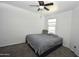Bedroom featuring a window, carpet and bed with gray headboard and bedding at 17829 W Sherman St, Goodyear, AZ 85338