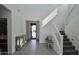 Inviting foyer with staircase, bench, and view to the entrance at 17829 W Sherman St, Goodyear, AZ 85338