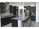 This modern kitchen includes stainless steel appliances, a kitchen island, and pantry at 17829 W Sherman St, Goodyear, AZ 85338