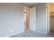 Bright bedroom with gray carpet and doors to a bathroom and closet at 18766 W Montebello Ave, Litchfield Park, AZ 85340