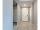 Bright entryway with light gray walls, tile flooring, and a white front door at 18766 W Montebello Ave, Litchfield Park, AZ 85340