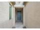 Inviting entryway with a blue front door, modern exterior lighting, and neutral stucco walls at 18766 W Montebello Ave, Litchfield Park, AZ 85340