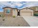 Charming single-Gathering home with stone accents, a two-car garage, and desert landscaping at 18766 W Montebello Ave, Litchfield Park, AZ 85340