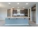 Modern kitchen showcasing granite countertops, a kitchen island, and stainless steel appliances at 18766 W Montebello Ave, Litchfield Park, AZ 85340
