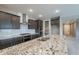 Kitchen island with granite countertops, a stainless steel sink, and a view of the pantry at 18766 W Montebello Ave, Litchfield Park, AZ 85340