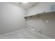 Bright laundry room featuring modern flooring, spacious countertops and washer and dryer hookups at 18766 W Montebello Ave, Litchfield Park, AZ 85340