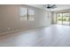 Spacious living room with neutral walls, ceiling fan, and sliding glass door to the backyard at 18766 W Montebello Ave, Litchfield Park, AZ 85340