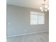 Bright living room with wood-look flooring, neutral walls, and modern lighting fixture at 18766 W Montebello Ave, Litchfield Park, AZ 85340