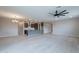Open-concept living area featuring an island kitchen, modern lighting, and tile flooring at 18766 W Montebello Ave, Litchfield Park, AZ 85340