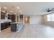 Open-concept kitchen and living area with gray cabinets, large island, and modern finishes at 18766 W Montebello Ave, Litchfield Park, AZ 85340