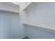 Spacious walk-in closet with wooden rods and shelving for optimal storage solutions at 18766 W Montebello Ave, Litchfield Park, AZ 85340