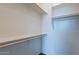 Large walk-in closet featuring white shelving and wooden rods for organized storage at 18766 W Montebello Ave, Litchfield Park, AZ 85340