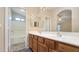 Bathroom with double sink vanity, framed mirror and tub shower combo at 1909 N 106Th Ave, Avondale, AZ 85392
