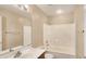 Bright bathroom features a large mirror and a shower-tub combo with white tiled walls at 1909 N 106Th Ave, Avondale, AZ 85392