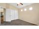 Neutral bedroom featuring carpet, ceiling fan and a closet with sliding doors, offering comfort and functionality at 1909 N 106Th Ave, Avondale, AZ 85392
